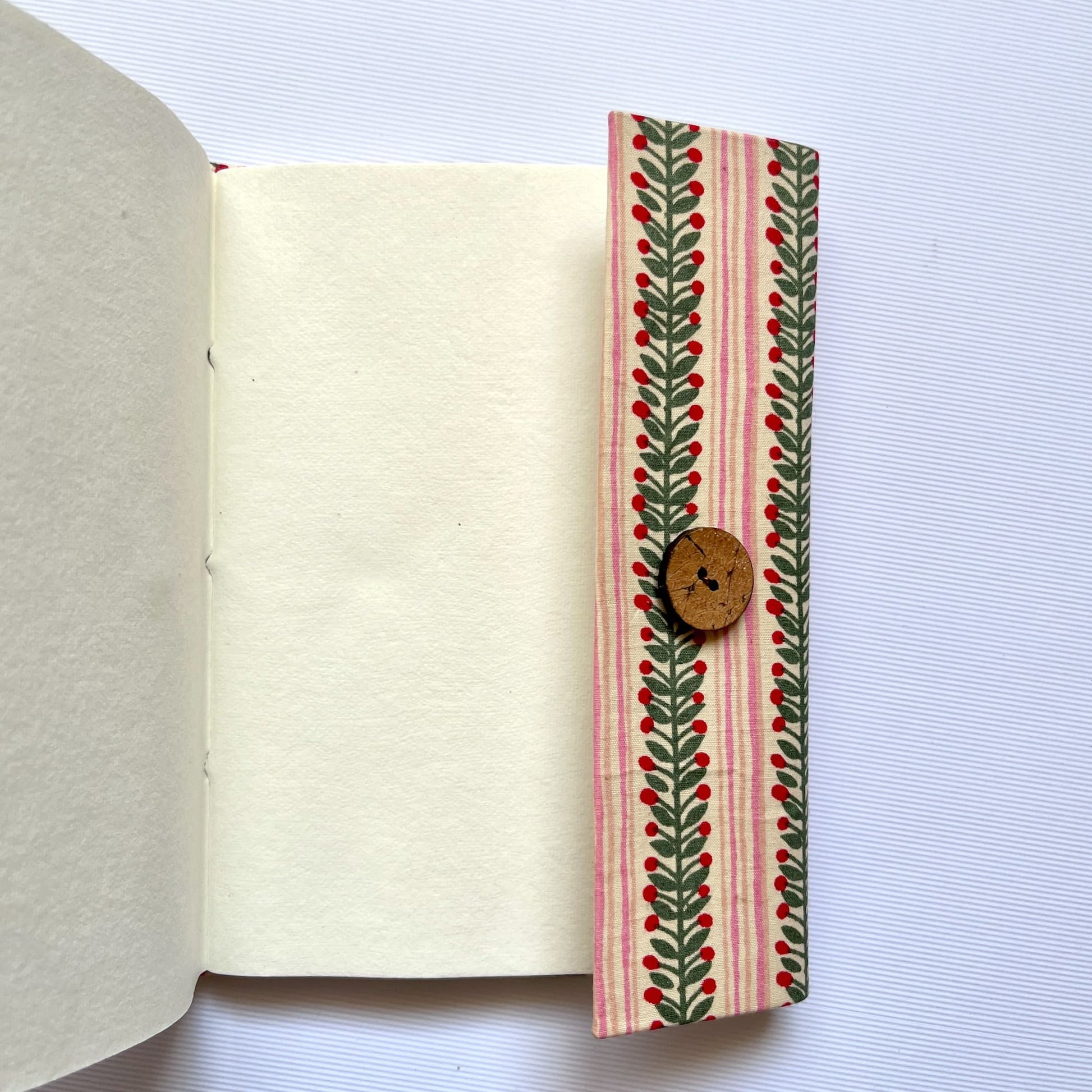 Berry Stripe Pink Diary opened to show handmade paper pages