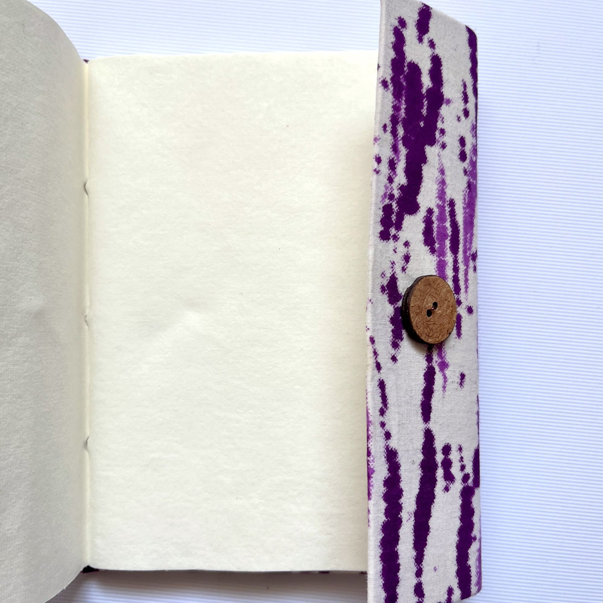 Abstract Stripe Purple Diary opened to show handmade paper pages