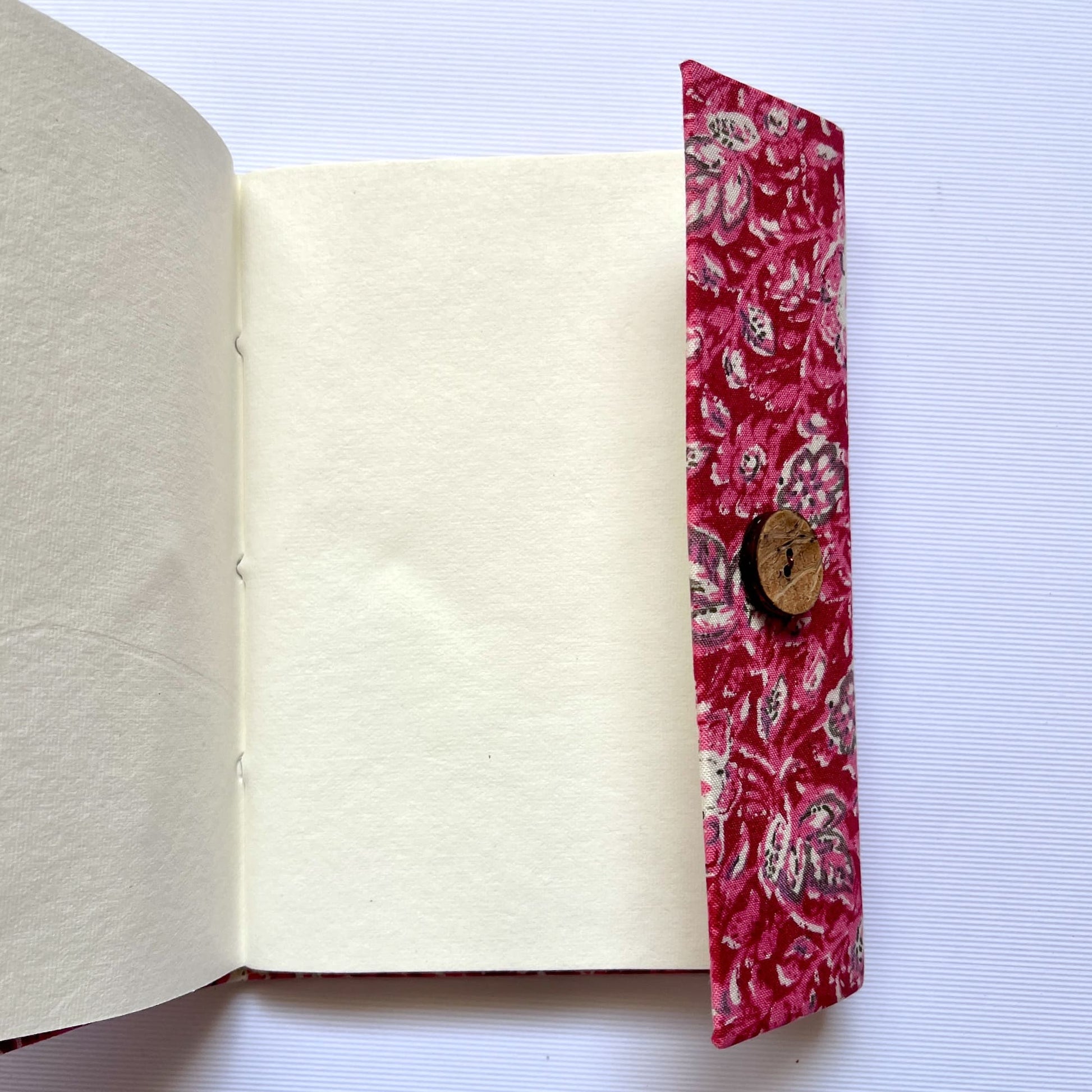 Paisley Floral Pink Diary opened to show handmade paper pages