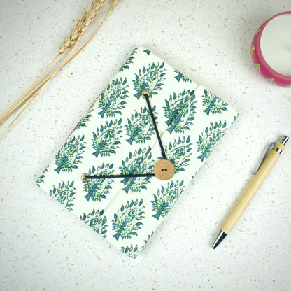 Leaf Print Green Diary styled flatlay with writing accessories