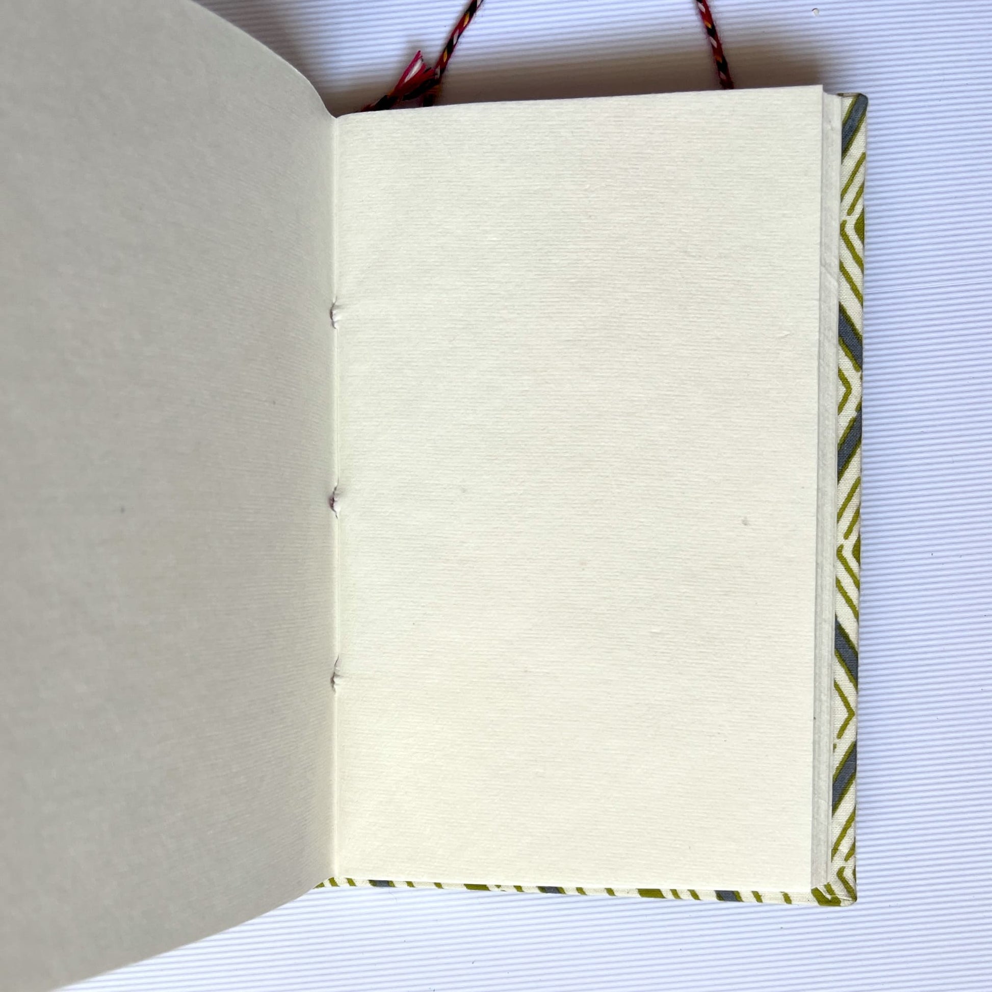 Chevron Green Diary opened to show handmade paper pages