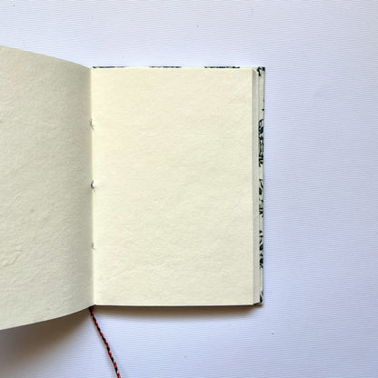 Tree Motif Green Diary opened to show handmade paper pages