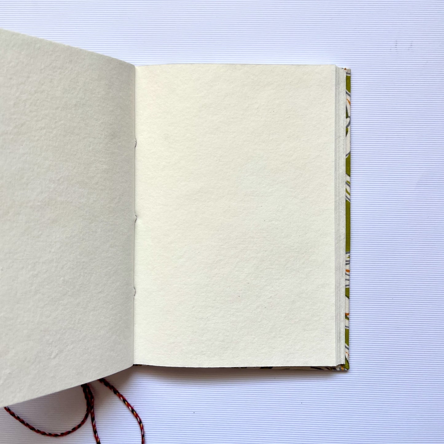 Lily Floral Green Diary opened to show handmade paper pages