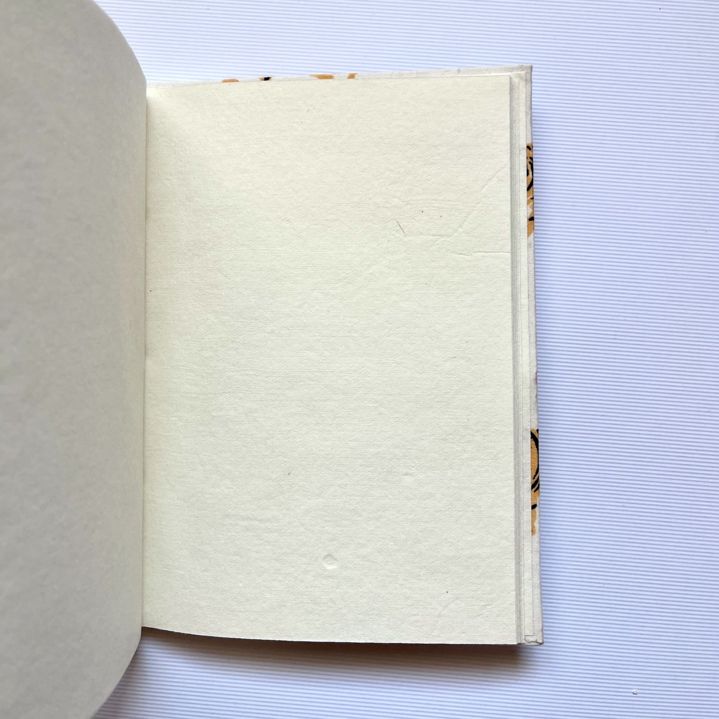 Tiger Print Yellow Diary opened to show handmade paper pages