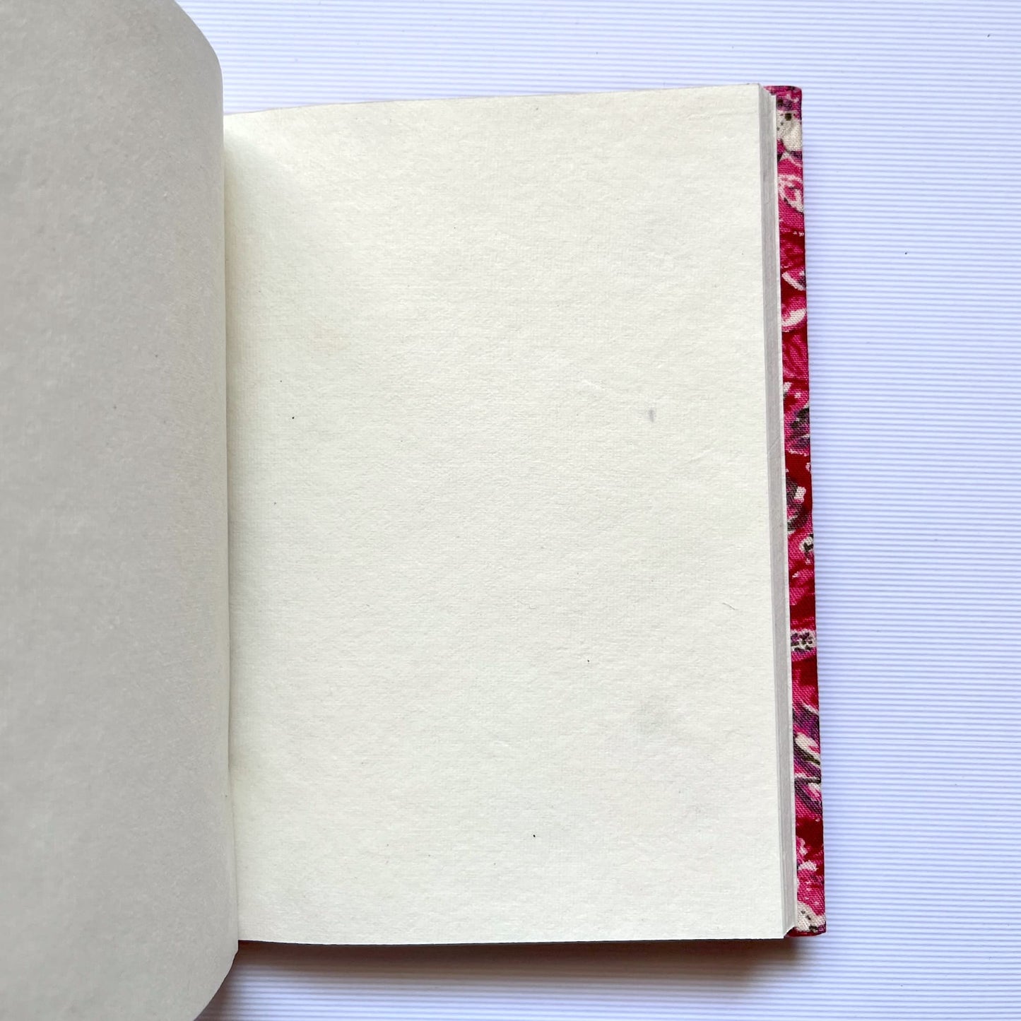 Floral Vine Pink Diary opened to show handmade paper pages
