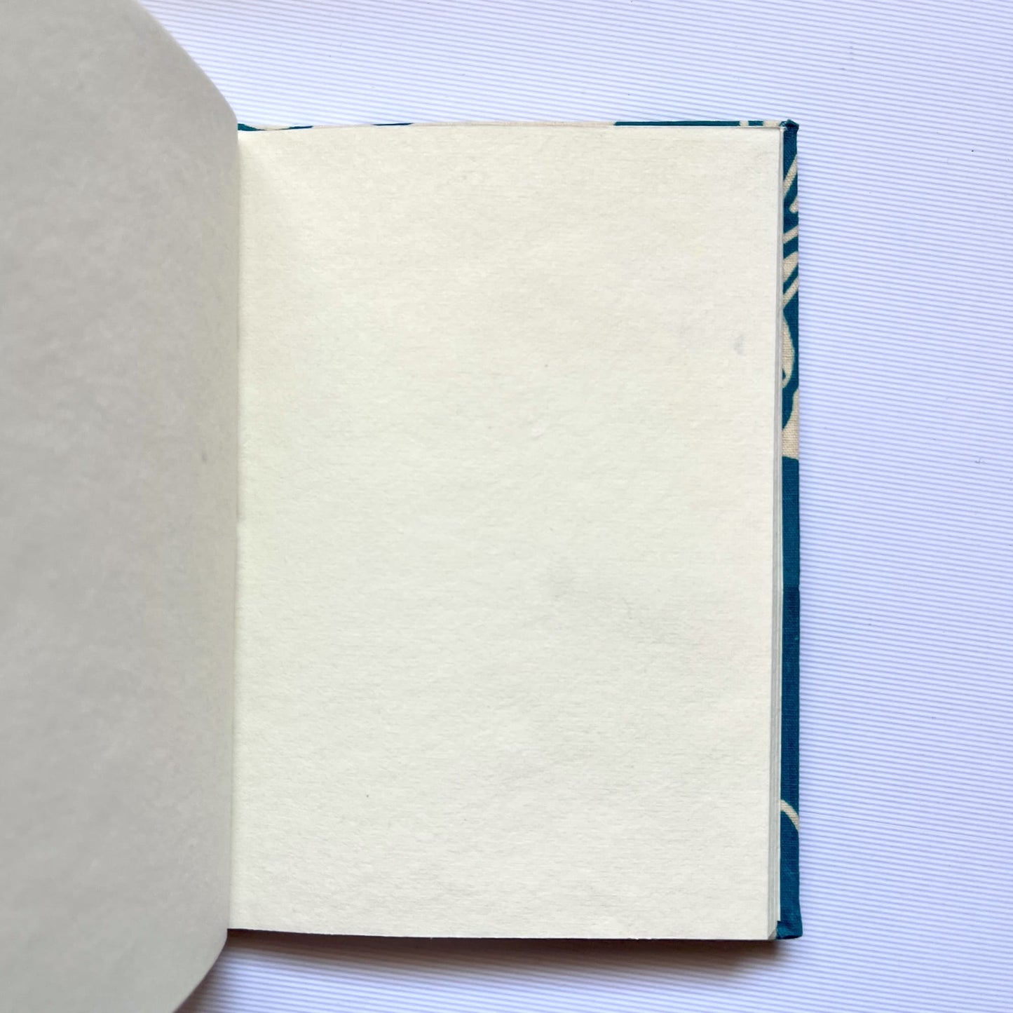 Rose Outline Blue Diary opened to show handmade paper pages