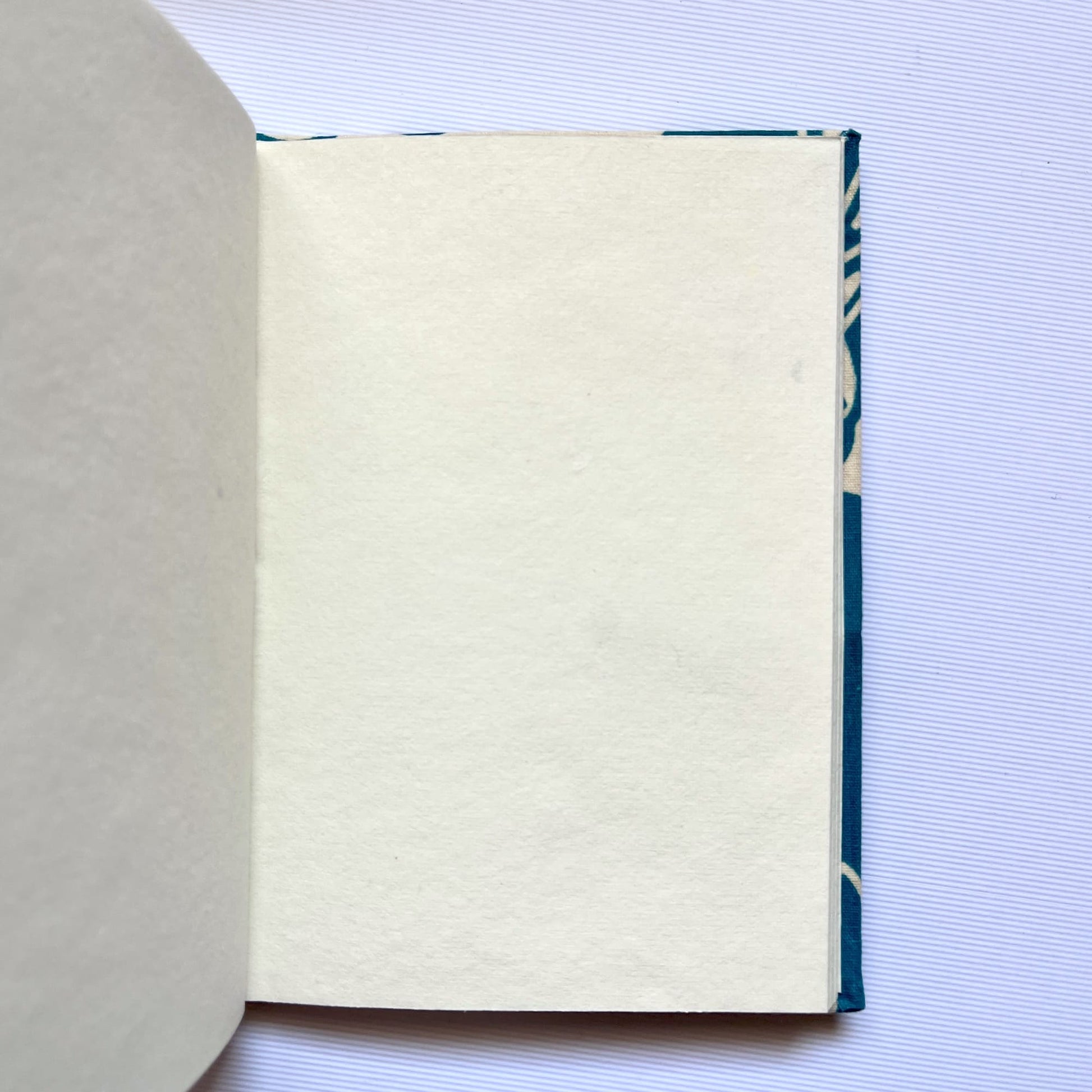 Rose Outline Blue Diary opened to show handmade paper pages