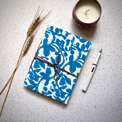 Bold Floral Blue Diary styled flatlay with writing accessories
