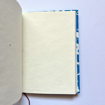 Bold Floral Blue Diary opened to show handmade paper pages