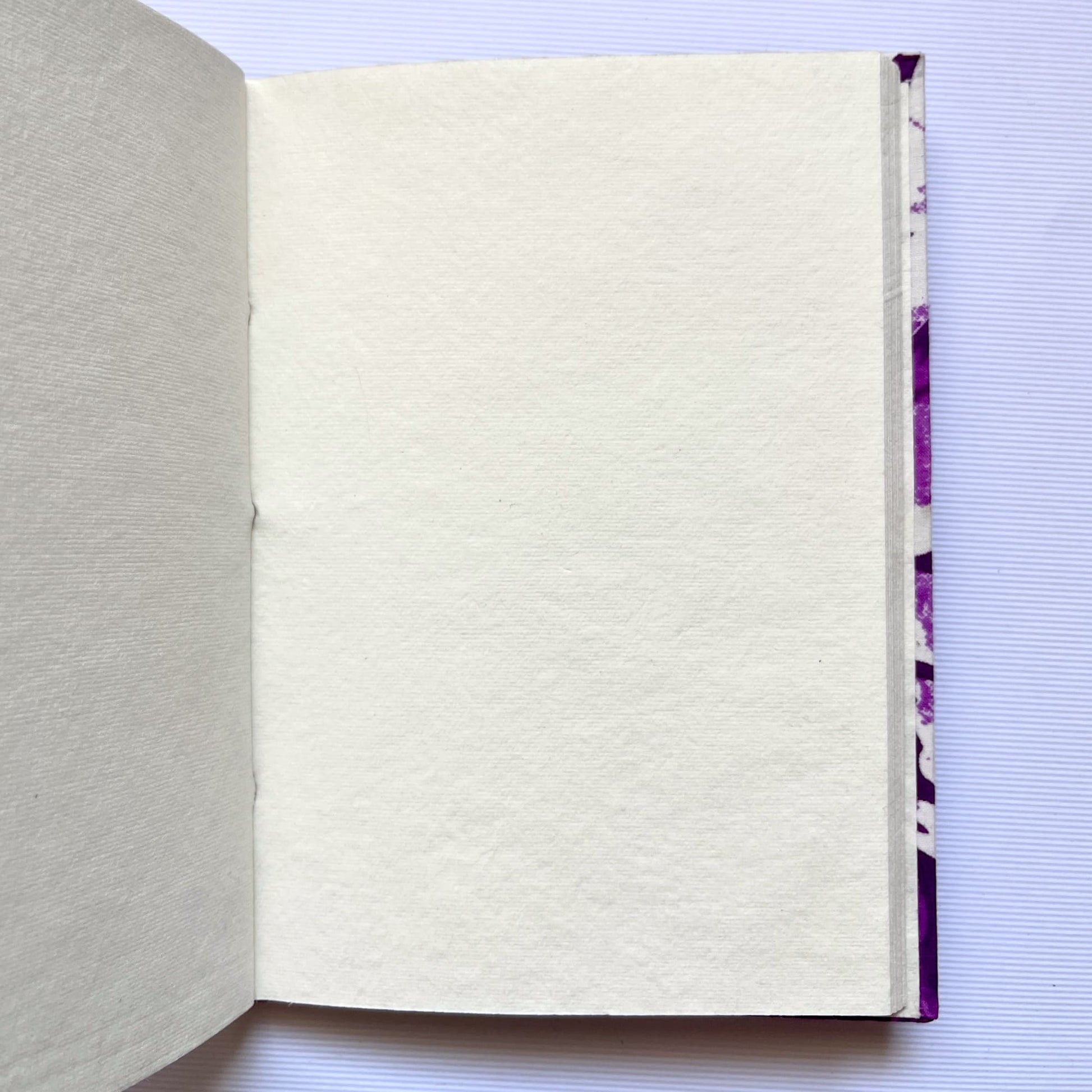 Floral Silhouette Purple Diary opened to show handmade paper pages