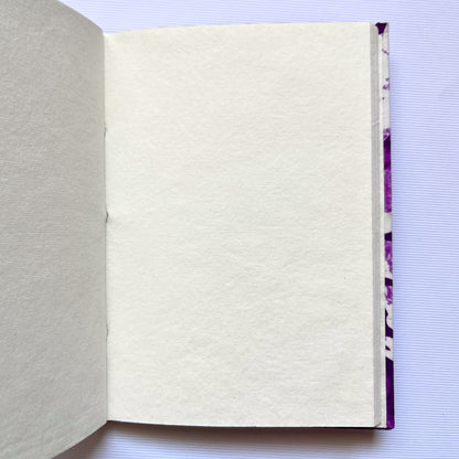 Floral Silhouette Purple Diary opened to show handmade paper pages
