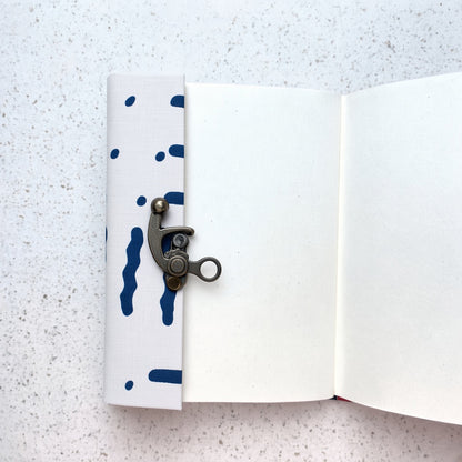 Blue Stripe lock diary opened to show handmade paper pages