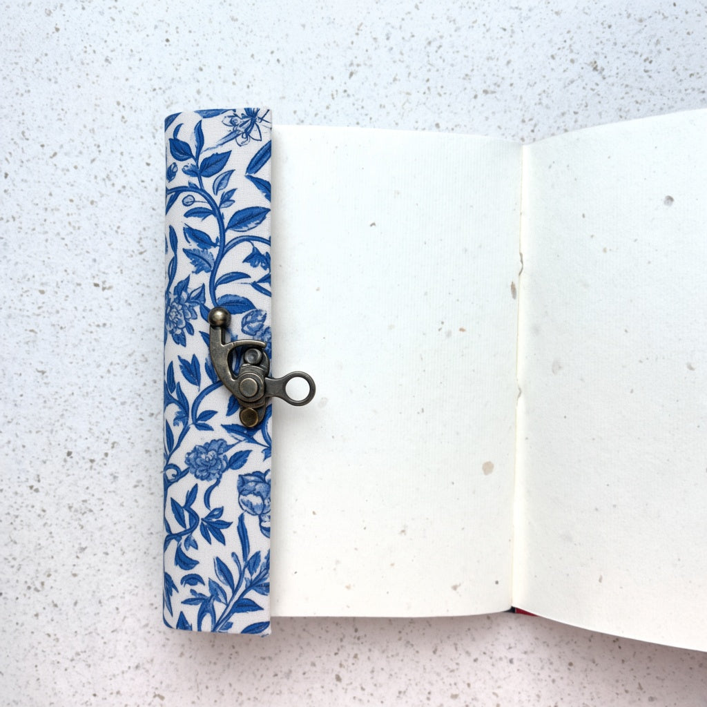 Blue Vine lock diary opened to show handmade paper pages